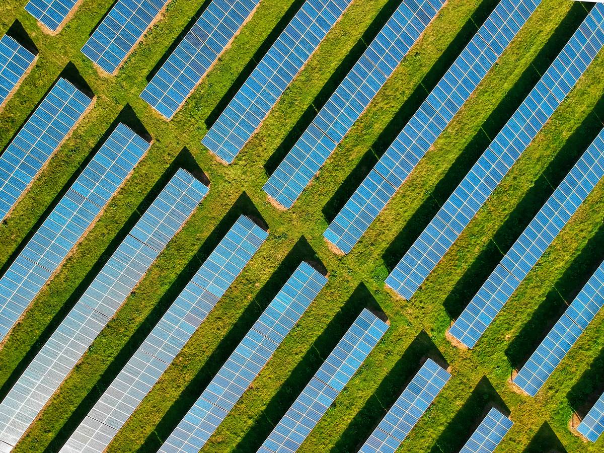 Rooftop installation of commercial property solar panels on a warehouse with optimized panel tilt angles