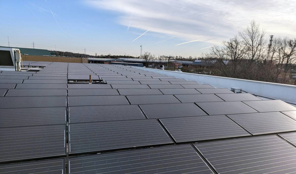 Rooftop installation of commercial solar panels uk on a warehouse in Manchester